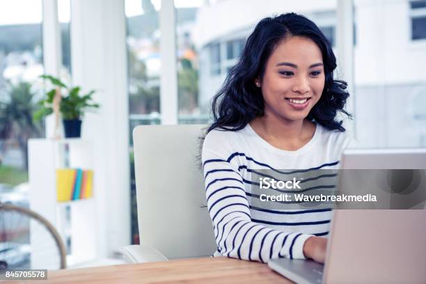Smiling Asian Woman Using Laptop Stock Photo - Download Image Now - Women, One Woman Only, Job Search