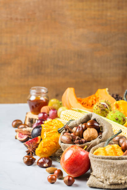 istock Fall autumn harvest background with pumpkin apple chestnut corn 845708844
