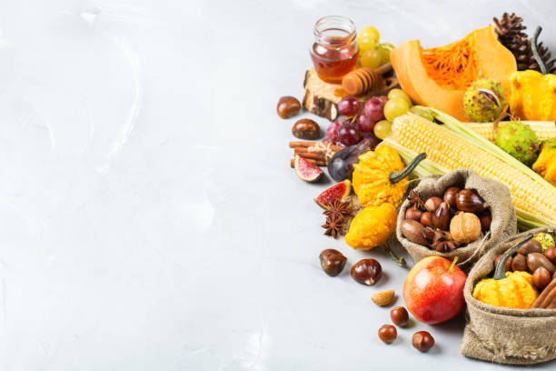 istock Fall autumn harvest background with pumpkin apple chestnut corn 845711932