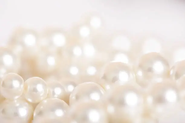 Photo of Pile of pearls on the white background