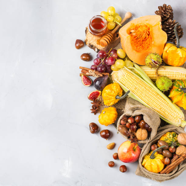 istock Fall autumn harvest background with pumpkin apple chestnut corn 845712494