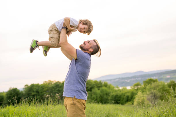 istock Father and son having fun outdoors in the meadow 845712622