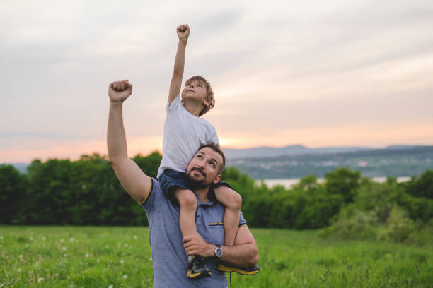 istock Father and son having fun outdoors in the meadow 845715162