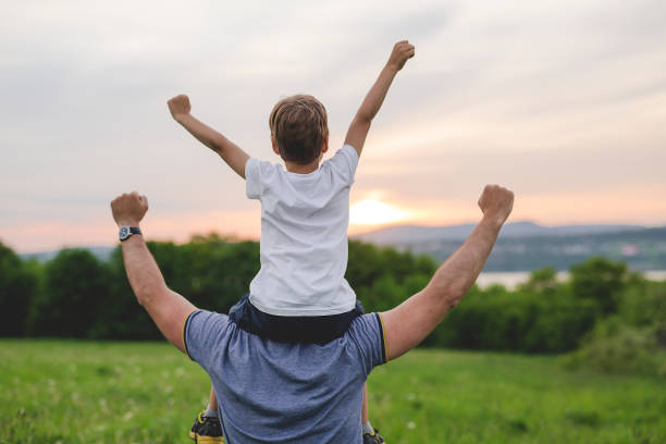 istock Father and son having fun outdoors in the meadow 845715188