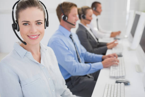 istock Business team working on computers and wearing headsets 845715592