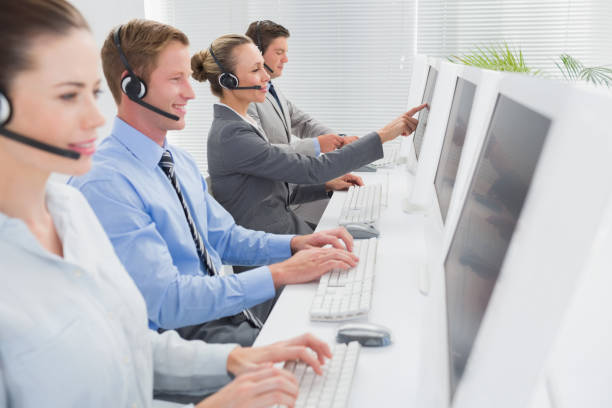 istock Business team working on computers and wearing headsets 845715624