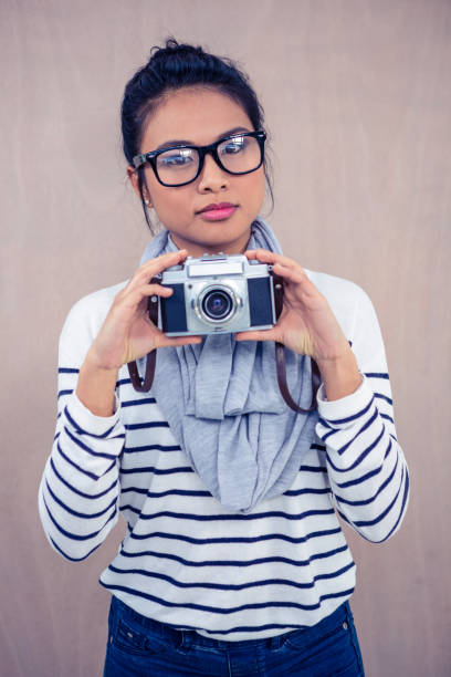 istock Attractive Asian woman holding camera 845716100