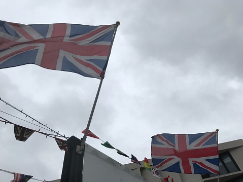 England flags blowing in the wind. Overcast sky