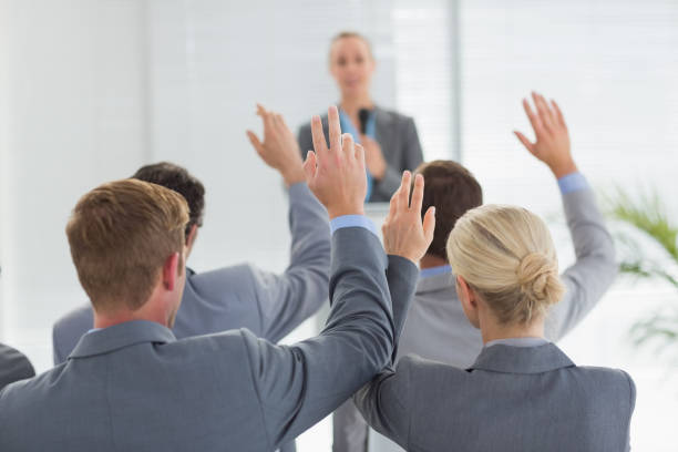 istock Business team raising hands during conference 845725488