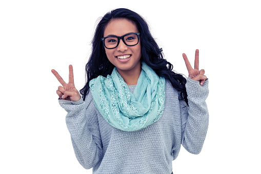 Asian woman making peace sign with hand on white background
