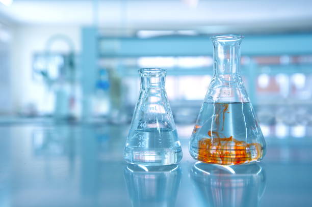 istock orange fluid in water in flask glassware in science chemical laboratory 845735828