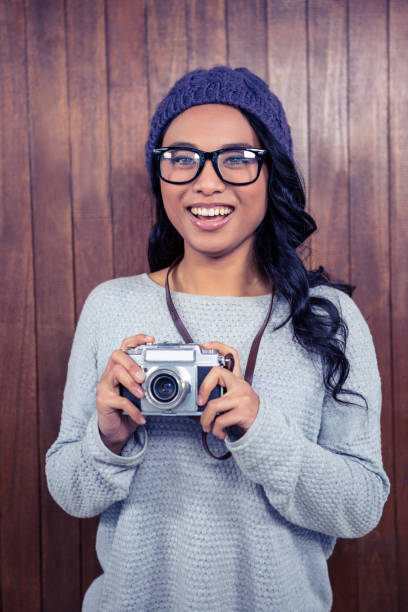 istock Asian woman holding digital camera 845736070