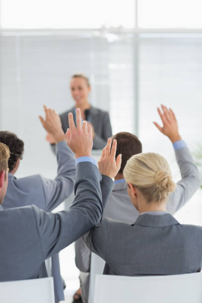 istock Business team raising hands during conference 845736276