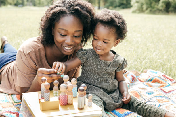 istock Playing outside the house with mom and dolls 845738968