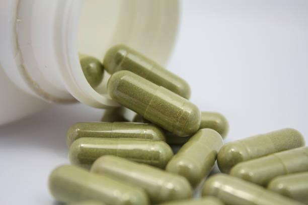 istock herbal capsules spilling out of a bottle 845739032