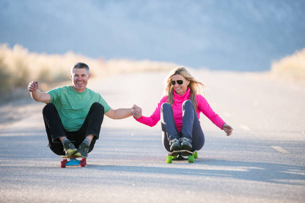 istock Silly couple playing on skateboards 845739954