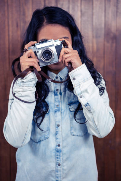 istock Asian woman taking picture with digital camera 845747866