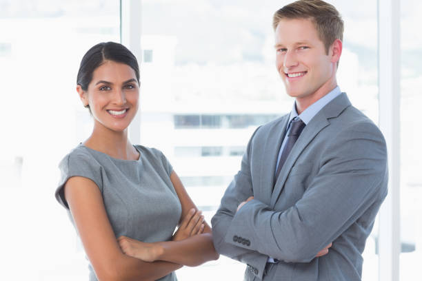 istock Smiling business colleagues smiling at camera 845748646