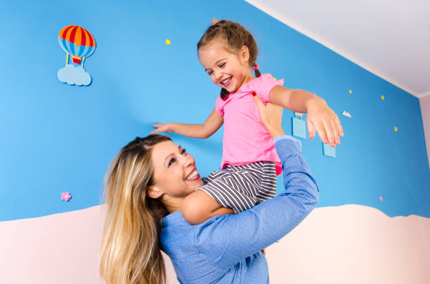 istock Ecstatic, happy mother and daughter playing 845754212