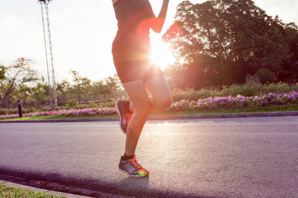 istock Runner feet running on road at park. 845757244