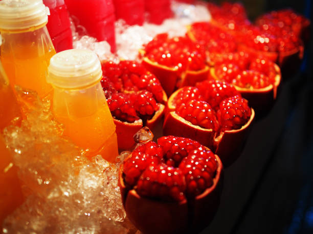 istock Top peeled pomegranate stacked arranged in ice pack, in night fruit stall cart 845757326