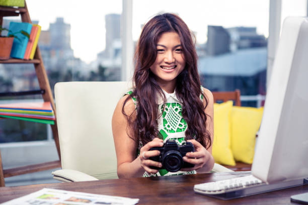 istock Smiling Asian woman holding camera 845760854