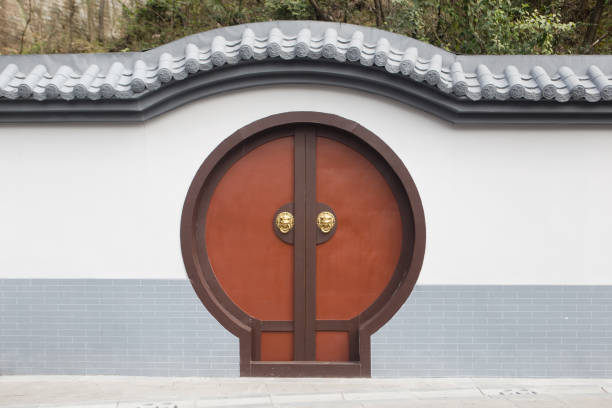 Moon Gate A Moon Gate is a circular opening in a garden wall that acts as a pedestrian passageway, and a traditional architectural element in Chinese gardens. shenyang stock pictures, royalty-free photos & images