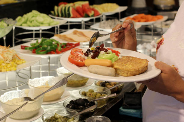 istock buffet food, customer scooping the food 845765980