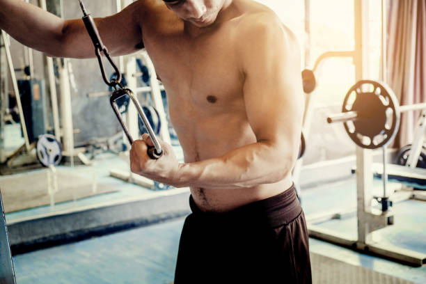 istock Fitness Strong Man Doing Heavy Weight Exercise on Machine in gym 845769600