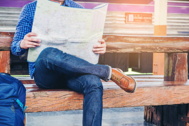 istock Tourist backpacker using map to travel at train station 845772282