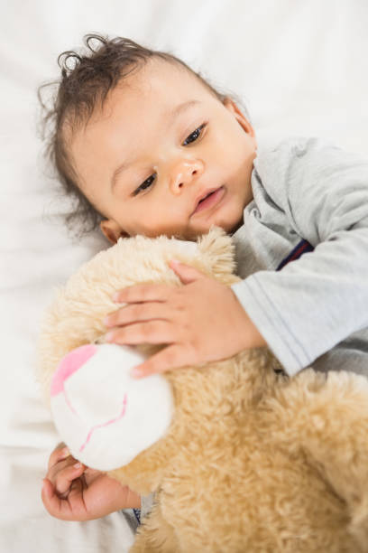 istock Cute baby holding plush 845773108