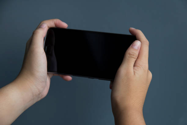 istock Female hand holding the smartphone Black color 845775464