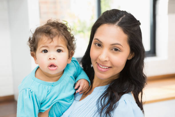 istock Smiling brunette holding her baby 845781688