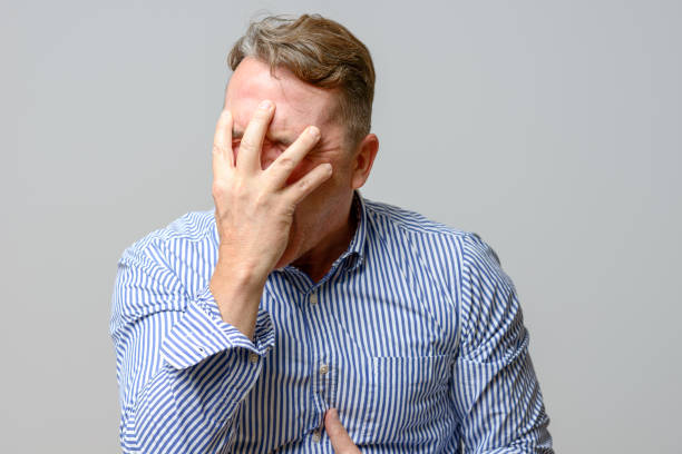 istock Middle aged man covering his face with his hands 845781810