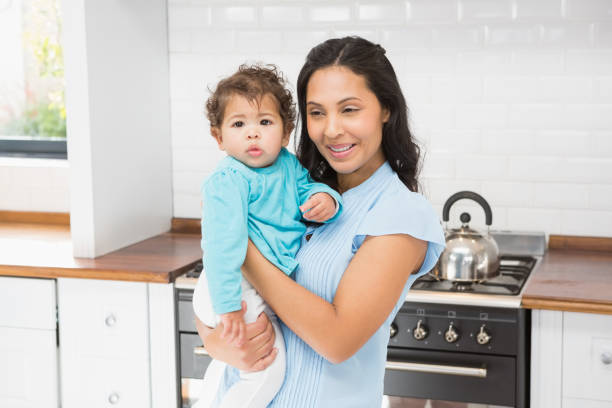 istock Smiling brunette holding her baby 845781992