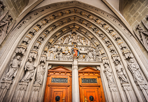 The main portal at the main gate of Saint Nicholas of Myre Parish Church of Freiburg, constructed around 1380, representing a Last Judgment, in Fribourg, Switzerland.