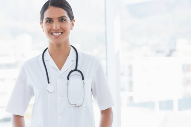 istock Happy doctor looking at camera beside windows 845782156