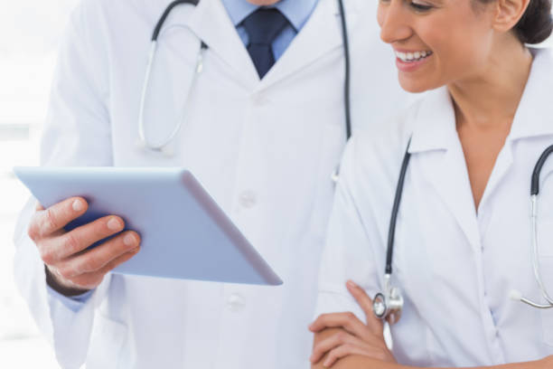 istock Happy doctors looking at clipboard 845782324