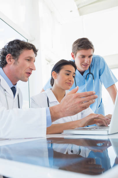 istock Team of doctors working on laptop computer 845782374