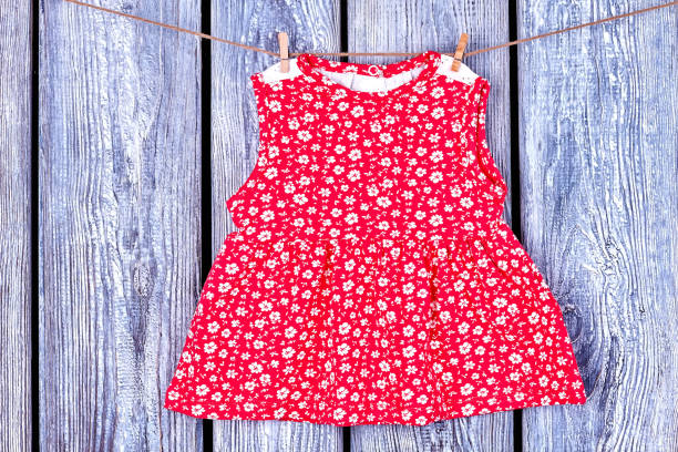istock Baby red dress hanging on clothesline. 845785920