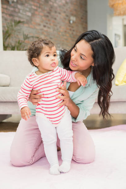 istock Mother with baby learning to walk 845790072