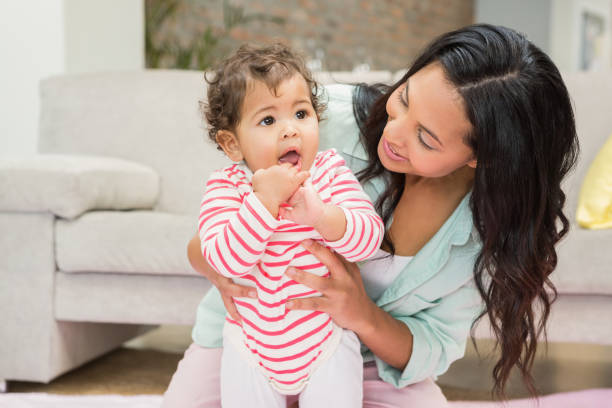 istock Mother with baby learning to walk 845790096