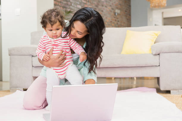 istock Happy mother with her baby using laptop 845790134