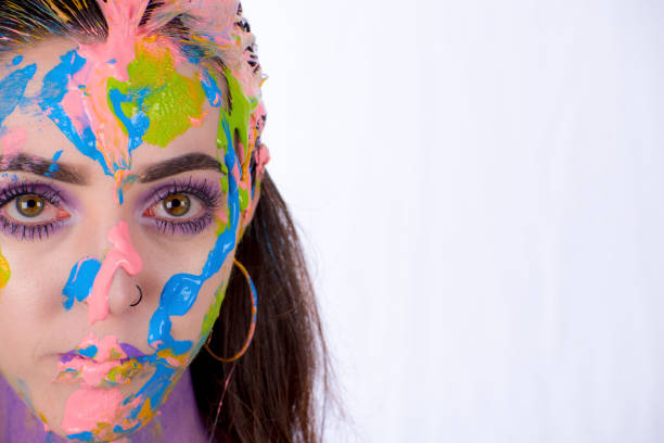 istock Woman with painted face looks into camera. 845793552