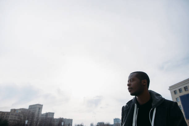 istock Thoughtful black male outdoors. Cloudy sky 845799688