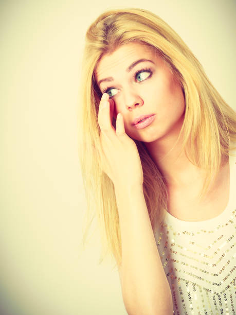sad woman crying on black background