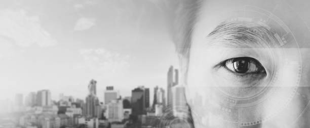 Double exposure, Asian businessman's eye, with futuristic technology visual effect and city skyline background, black and white colored