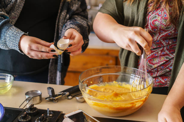 istock two sisters following recipe to make pumpkin pie 845805274