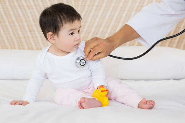 istock Cute baby being visited by doctor 845809760