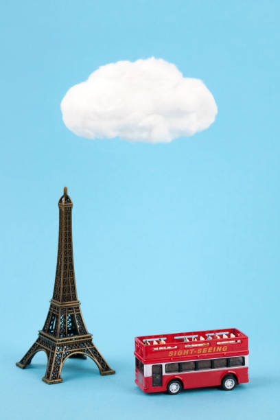 istock miniature eiffel tower and tourist bus on sky blue background 845809858